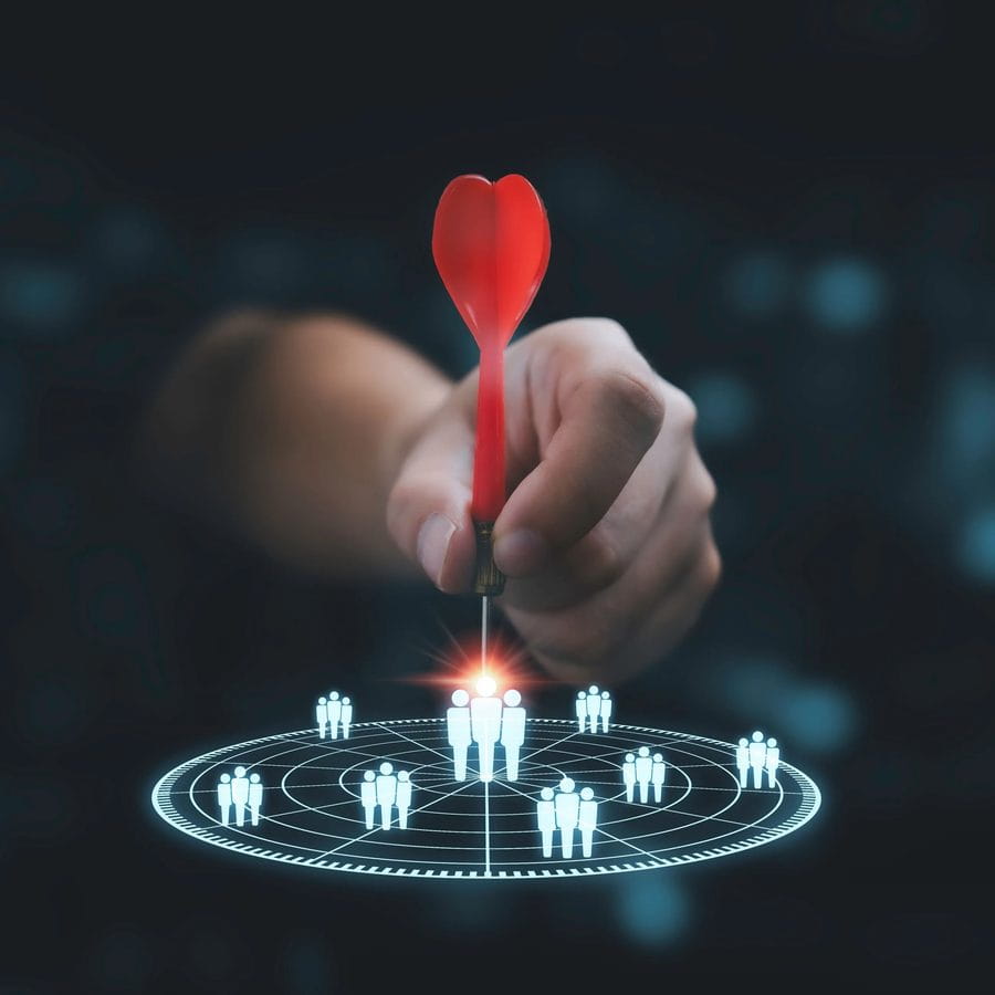 Hand aiming a dart at a target of people icons
