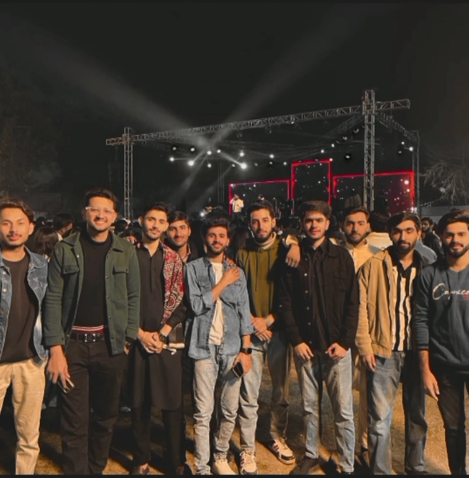 A group photo of attendees at an outdoor evening event.